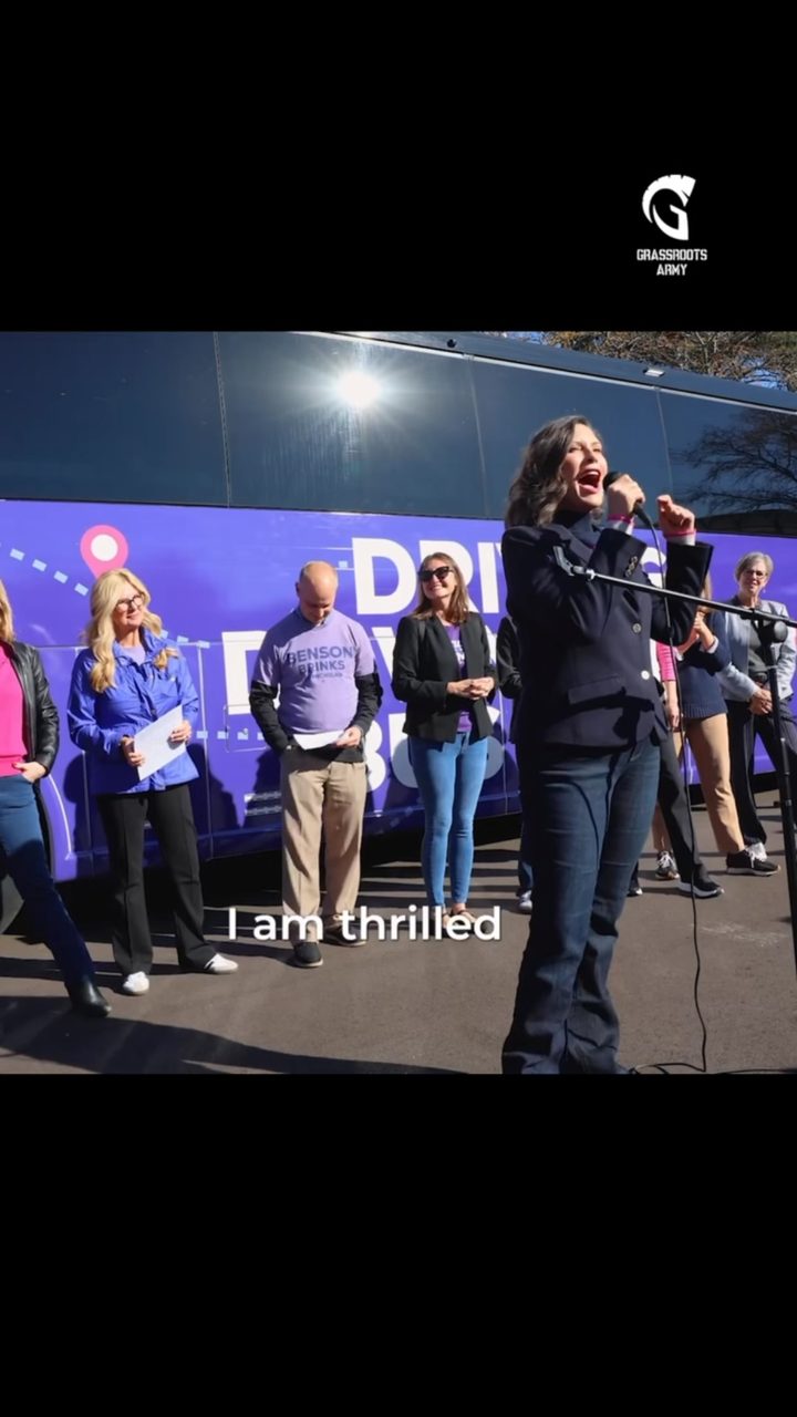 Video still of Governor Whitmer speaking at a rally with the caption &lsquo;I am thrilled&rsquo;